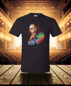 Black t-shirt of Bob Marley on stage with seats and lights in the background.