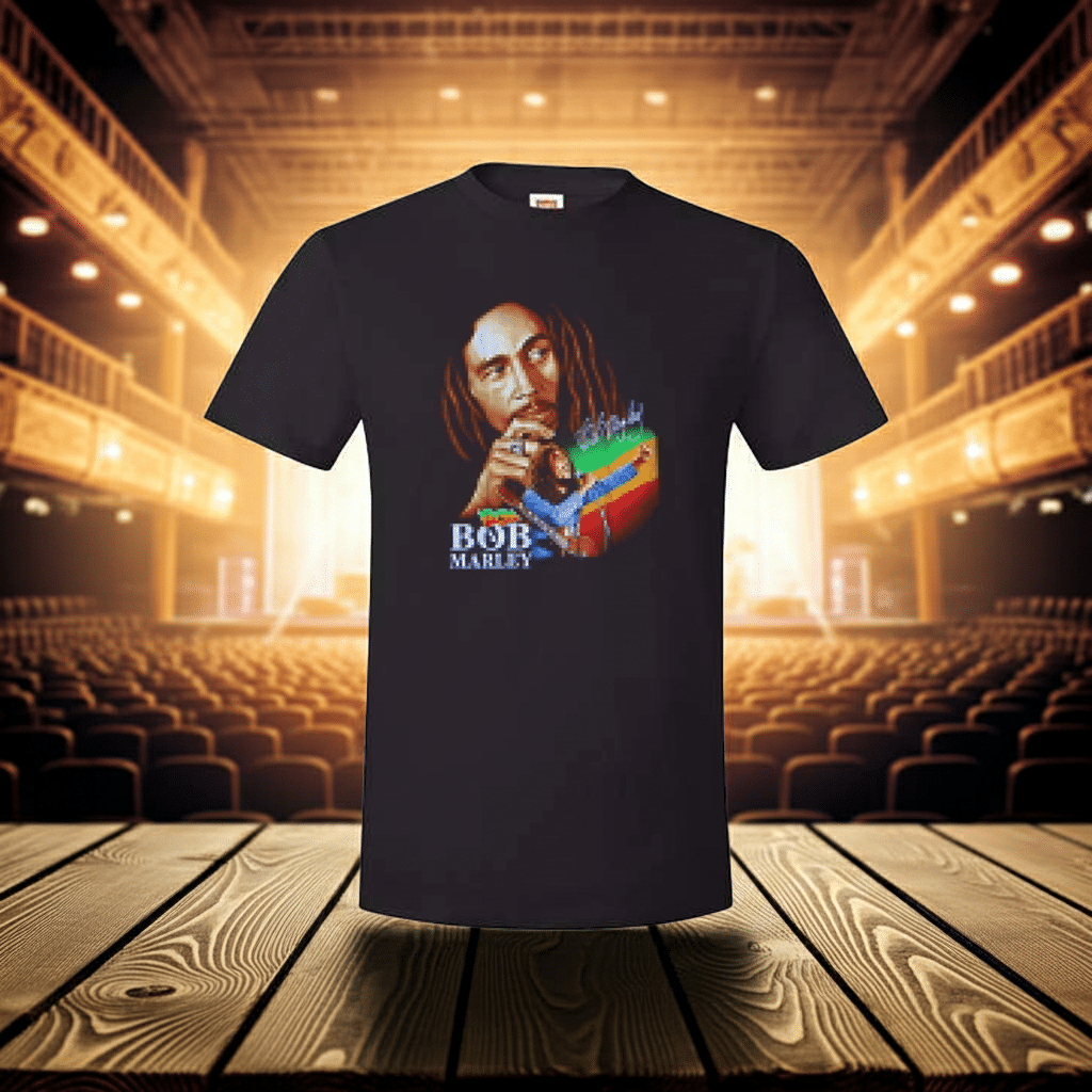 Black t-shirt of Bob Marley on stage with seats and lights in the background.
