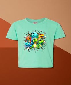 Green Girls Dino Tee. There are several small dinos that have busted out of the wall.